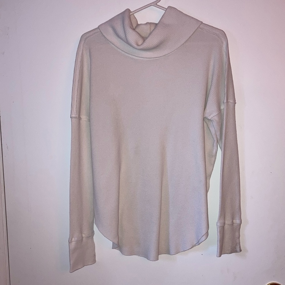 TNA beige turtleneck with marks on bottom of sleeves. Size M